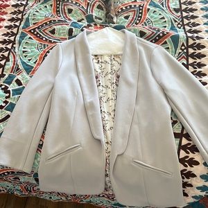 Skies are blue  silver or light grey fitted blazer.